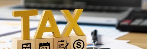 tax-wooden-letter-and-tax-icon-on-wooden-block-pay-2024-11-27-09-19-59-utc